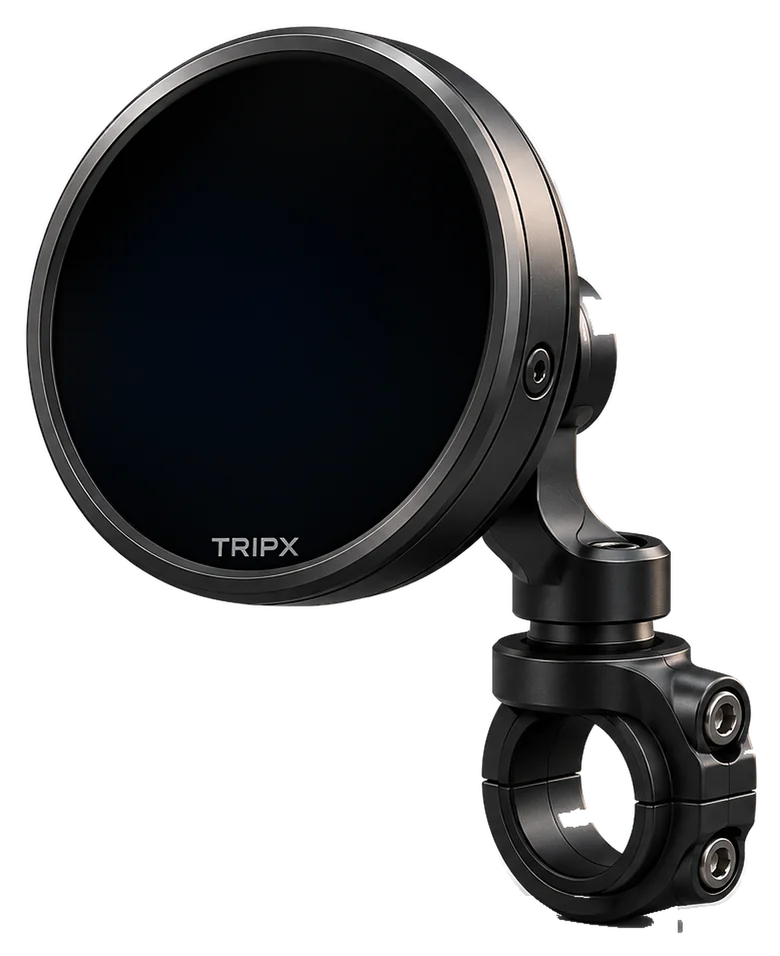 The TRIPX pod on its handlebar mount: a round display in a thin dark gunmetal rim, on a short arm above a two-bolt bar clamp. The screen shows a right turn onto 12th Main Road.